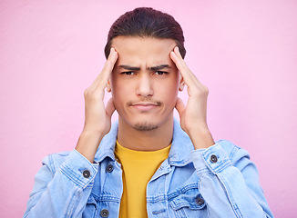 Image showing Portrait, stress and man with headache in studio isolated on a pink background. Mental health, anxiety and face of depressed and sad male model with depression, pain or migraine, burnout or head ache