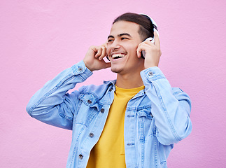 Image showing Headphones, man and smile on pink background, wall backdrop or studio mockup. Excited guy listening to music, sound and streaming audio media with freedom, happy face and hearing radio for podcast