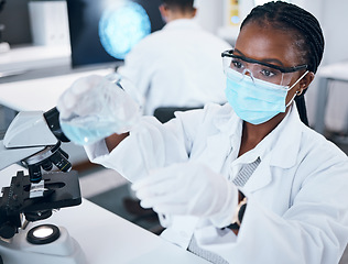 Image showing Science, covid and reaction with a black woman doctor working in a laboratory for research or innovation. Medical, analytics and development with a female scientist at work in a lab for chemistry