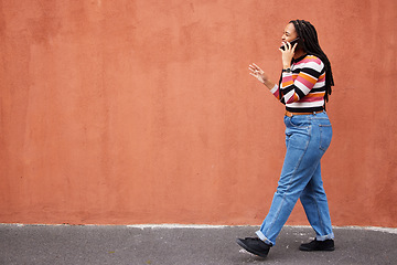 Image showing Mockup, phone call and black woman in a city street against orange background for advertising. Walking, talking and girl speaking on copy space outdoor for relax, trip and social network on space