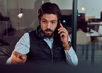 Image showing Phone call, programmer and man talking in office, chatting and speaking to contact at night. Information technology, pointing and thinking male employee or coder with mobile smartphone for networking