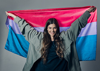 Image showing Bisexual flag, pride and happy woman, lgbtq and freedom to love, inclusion and equality, protest for human rights. Gay, trans and identity, politics and community in portrait on studio background