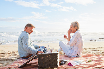 Image showing Senior couple, romantic beach picnic and smile together in summer for conversation, memory and comic time. Elderly man, old woman and basket for food, wine and outdoor for sunshine, waves and love