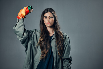 Image showing Woman, protest and rainbow fist for gay, LGBTQ or human rights against gray studio background. Portrait of female activist standing ready in fighting for equality, empowerment or sexuality on mockup