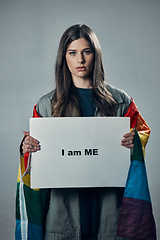 Image showing Woman, protest and poster in pride for gay, LGBTQ equality or human rights against gray studio background. Portrait of confident female activist with I am me message board for sexuality empowerment