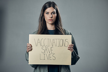 Image showing Woman, protest and poster for vaccination, flu shot or health and safety against gray studio background. Portrait of female activist with billboard for healthcare, covid or vaccine message on mockup