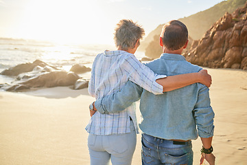 Image showing Beach, love and an old couple walking on the sand by the ocean or sea for romance or dating at sunset. Nature, summer or back with a mature woman and man taking a romantic walk together on the coast