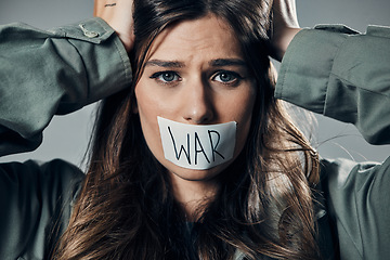 Image showing Woman, face and protest with tape on mouth in fear for cold war, armageddon or doomsday against gray studio background. Female activist with voice message to stop or end global violence in society