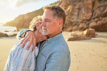 Image showing Beach, senior couple and hug of mature people with love and marriage by the ocean. Retirement, summer holiday and sea vacation of a man and woman together feeling love and support in nature on sand