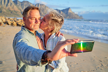 Image showing Selfie, kiss and senior couple at the beach for a vacation memory in retirement in Argentina. Affection, love and elderly man and woman taking a photo at the ocean during a date on valentines day