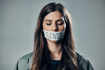 Image showing Woman, tape and mouth with silence for protest, social activism and fight against covid 19 by background. Human rights, gen z girl and studio with healthcare opinion for freedom, choice and vision