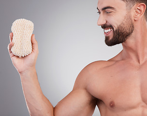 Image showing Hygiene, man and sponge for cleaning, smile and wellness with guy on grey studio background. Male, gentleman and skincare for washing, happiness and grooming routine for health, smooth and soft skin