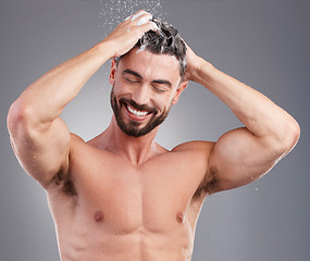 Image showing Shower, shampoo and cleaning hair with a man in studio on a gray background for hygiene or grooming. Water, haircare and washing with a happy or handsome young male in the bathroom keratin treatment