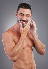 Image showing Shower, water and portrait of man with soap in studio gray background for wellness, grooming and beauty. Skincare, bathroom hygiene and male smile for washing, clean face and beard for healthy skin