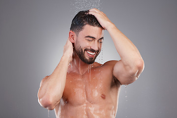 Image showing Shower, keratin and cleaning hair with a man in studio on a gray background for hygiene or grooming. Water, haircare and washing with a handsome young male in the bathroom for shampoo treatment
