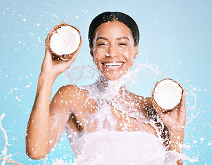 Image showing Coconut milk, beauty and portrait of woman for healthy skin and diet on a blue background. Face of aesthetic model person with splash, skin care and fruit for sustainable facial health and wellness