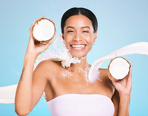 Image showing Skin care, beauty and woman portrait with coconut for healthy skin and diet on a blue background. Face of aesthetic model person with milk splash and fruit for sustainable facial health and wellness