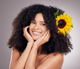 Image showing Portrait, sunflower and black woman with skincare, cosmetics and dermatology on grey studio background. Face detox, African American female and lady with plants, happiness and makeup for smooth skin