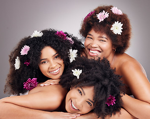 Image showing Friends, hair care and portrait of black women with flowers in studio isolated on a gray background. Floral cosmetics, organic makeup and face of group of girls with flower for beauty and aesthetic.