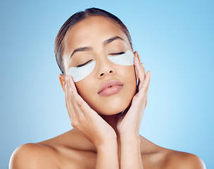 Image showing Skincare, mask for eyes and face of woman on blue background for wellness, cosmetics and facial treatment. Beauty, luxury spa and girl relax with eye pads for dermatology, healthy skin and self care