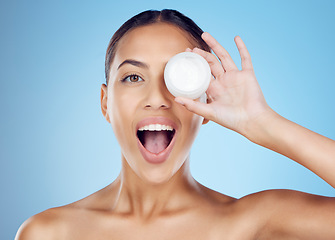 Image showing Beauty product, surprised portrait and facial cream with a model holding skincare treatment. Sunscreen, face lotion and dermatology wellness of a young female with happiness from self care in studio