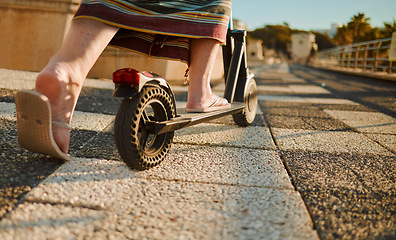 Image showing Scooter, feet and travel with a senior woman using eco friendly transport to commute on the promenade. Freedom, holiday and adventure with an elderly female traveling overseas on summer vacation