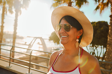 Image showing Travel, peace and senior woman at the beach for summer, walk and weekend fun in Bali. Sun, smile and elderly person on holiday at the sea to relax during the start of retirement by the ocean