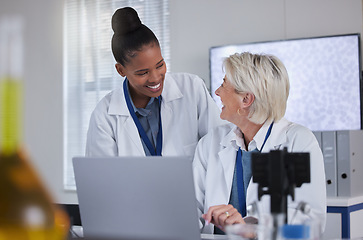 Image showing Teamwork, laptop and collaboration of doctors in laboratory for medical research or science. Computer, comic and researchers, black woman and senior female, talking and laughing at funny comedy meme.