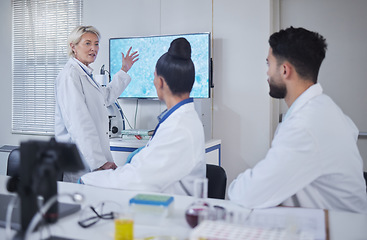 Image showing Science, presentation and woman scientist in the laboratory meeting, training or seminar. Innovation, leadership and senior female speaker presenting research discovery to team with technology in lab