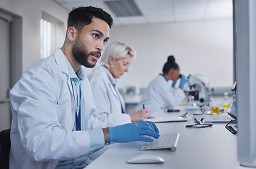 Image showing Typing, focus scientist working on computer in lab for medical search, innovation or science study in hospital. Medicine, internet or group of doctors on tech for healthcare or wellness DNA research