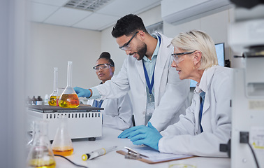 Image showing Chemistry, science and team with liquid in lab for medical research, study and vaccine development. Biotechnology, pharmaceutical and group of scientists with sample for analysis, test and experiment