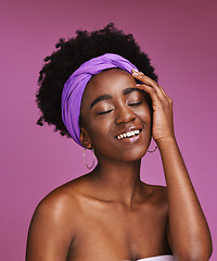 Image showing Face, beauty and skincare with a model black woman on a pink background in studio for natural care. Facial, hair and headband with an attractive young female posing to promote cosmetic treatment