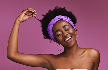 Image showing Hair, beauty and afro with a model black woman on a pink background in studio for natural care. Face, haircare and headband with an attractive young female posing to promote cosmetic treatment