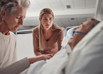 Image showing Sick, senior and family with a man in hospital for medical support with sad and worried people. Healthcare, ill and woman and daughter with an elderly patient after an accident, injury or dying