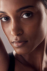 Image showing Portrait, skin and beauty with a model indian woman in studio on a gray background closeup for cosmetics. Face, skincare and eyes with an attractive young female posing indoor for natural dermatology