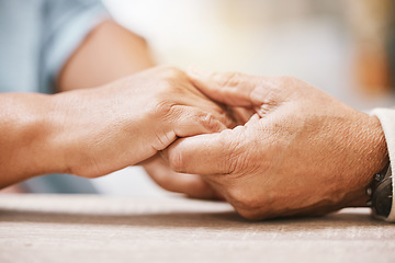 Image showing Love, praying or old couple holding hands together in a Christian home in retirement with hope or faith. Jesus, religion or belief with a senior man and woman in prayer to god for spiritual bonding