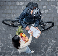 Image showing Signature, courier and woman with grocery delivery, supermarket service and giving of food. Ecommerce, package and above of a customer signing a document for groceries from a retail worker in street