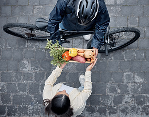 Image showing Grocery delivery, courier and cycling man with retail sales product, shopping nutritionist or food shipping container. Logistics supply chain, customer top view and distribution person with bicycle