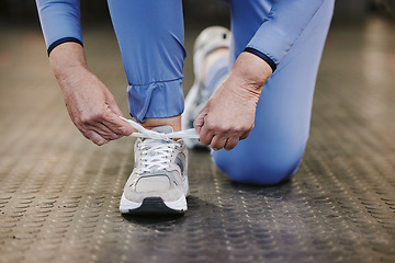 Image showing Sports, hands and tie shoes in gym to start workout, training or exercise for wellness. Fitness, athlete health or senior woman tying sneakers or footwear laces to get ready for exercising or running