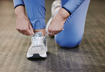 Image showing Hands, sports and tie shoes in gym to start workout, training or exercise for wellness. Fitness, athlete health or senior woman tying sneakers or footwear laces to get ready for exercising or running