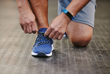 Image showing Hands, tie shoes and fitness in gym to start workout, training or exercise for wellness. Sports, athlete and man tying sneakers or footwear laces to get ready for exercising or running for health.