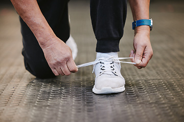 Image showing Fitness, tie shoes and hands in gym to start workout, training or exercise for wellness. Sports, athlete health and senior man tying sneakers or footwear laces to get ready for exercising or running.