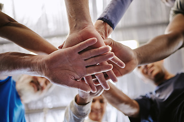 Image showing Teamwork, hands together and low angle of people in gym for motivation, solidarity and team building. Collaboration exercise, group of friends or retired senior men and women huddle for workout goals