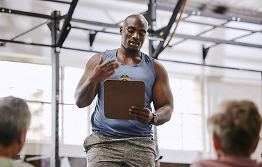 Image showing Coaching, gym checklist and black man talking to senior clients at training introduction, welcome or membership. Personal trainer fitness, workout or exercise schedule, sign up and USA community club