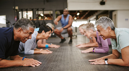 Image showing Senior people, fitness and plank with personal trainer in class for workout, core exercise or training at gym. Elderly group in coaching ab session for strong abdominal muscles on gymnasium floor