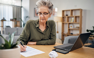 Image showing Focus, writing and senior woman for asset management, planning and paperwork of financial investment. Insurance, budget ideas or taxes on laptop of boss, executive or entrepreneur in home living room