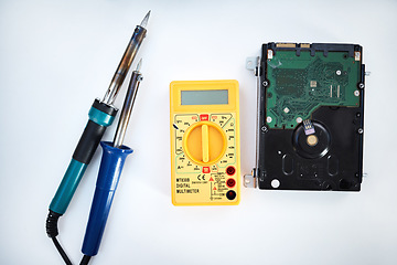 Image showing Tools to fix computer parts, hard drive and isolated on white background, technology and engineering in repair workshop. Hardware maintenance, problem diagnosis and machine assembly in empty studio.