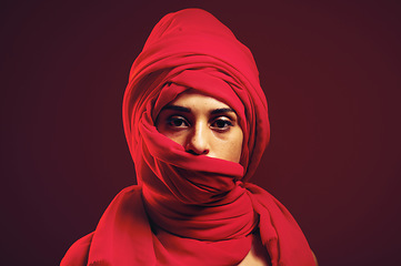 Image showing Hijab, muslim and portrait of a islamic woman in studio with dark background. Serious, covered and red arab head dress with a young person with religious, culture and islam fashion scarf with mockup