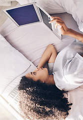 Image showing Lazy, sad and woman lying down with a laptop watching or streaming movie, website or app in a home, house or apartment. Rest, break and young black female using in internet subscription to relax