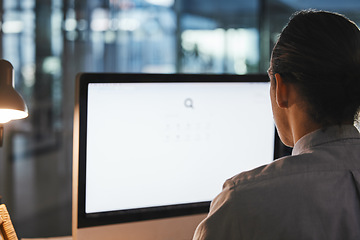 Image showing Man, computer and green screen on mockup at night for advertising, marketing or branding at the office. Male employee working on PC or desktop with mock up display in research, advertisement or app